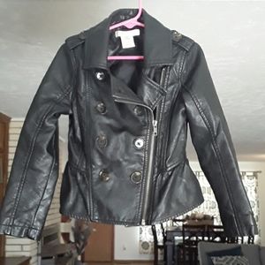 Black faux leather, zipper, ruffle in the back